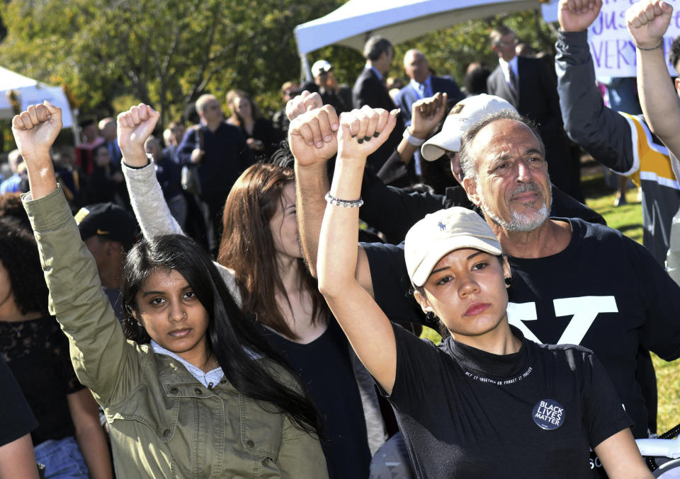 Protesters raise their arms in support of Kennesaw State cheerleaders in October. (Atlanta Journal-Constitution via AP)