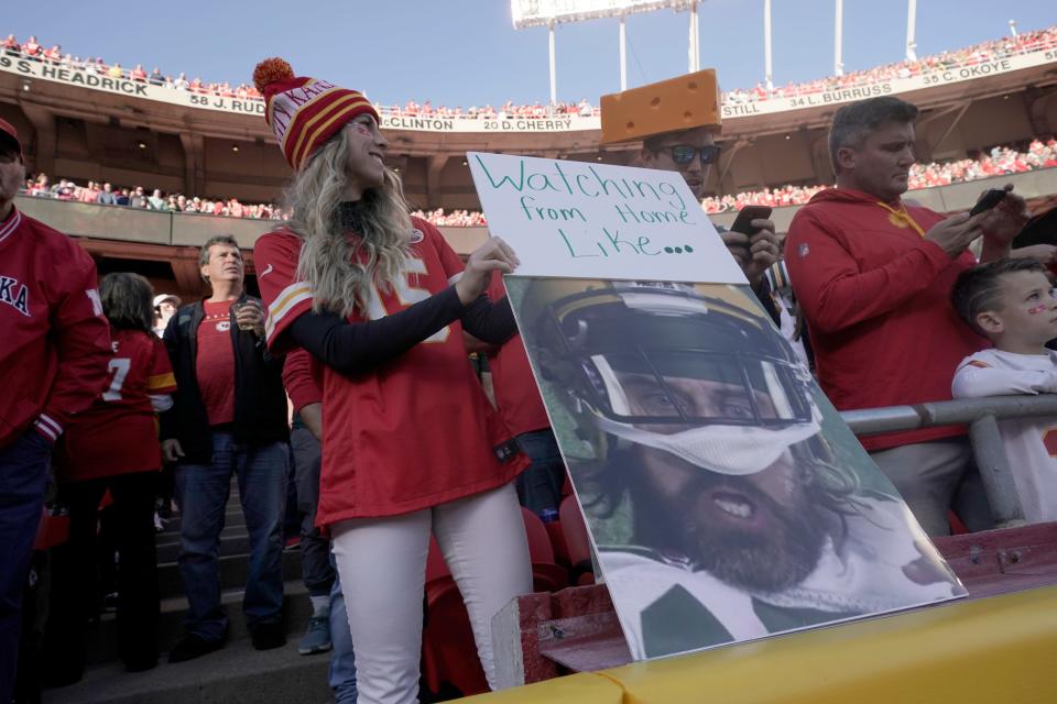 A Kansas City Chiefs fan holds up a sign with the photograph of Green Bay Packers quarterback Aaron Rodgers during the first half of an NFL football game between the Kansas City Chiefs and the Green Bay Packers on Sunday.