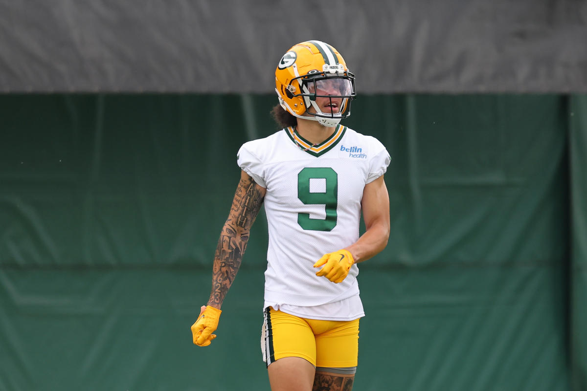 Christian Watson of the Green Bay Packers warms up before the