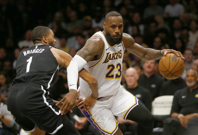 Los Angeles Lakers forward LeBron James (23) drives around Brooklyn Nets guard Mikal Bridges.