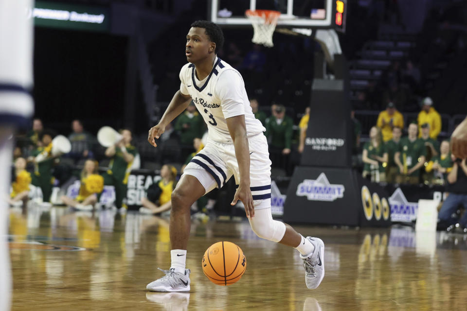 Oral Roberts G Max Abmas (3) dribbles the ball up the court against North Dakota State during the second half of an NCAA college basketball game for the Summit League tournament championship Tuesday, March 7, 2023, in Sioux Falls, S.D. (AP Photo/Josh Jurgens)