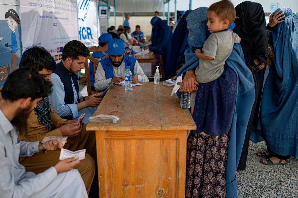 Internally displaced Afghan women stand in line to identify themselves and get cash as they return home, at the United Nations High Commissioner for Refugees (UNHCR) camp on the outskirts of Kabul, Afghanistan, in a July 28, 2022 file photo. / Credit: WAKIL KOHSAR/AFP/Getty