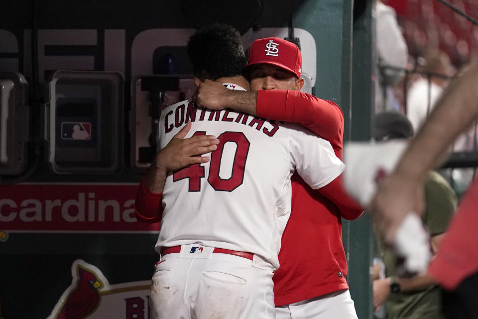 St. Louis Cardinals catcher Willson Contreras, left, gets a hug from manager Oliver Marmol in the dugout following an 11-3 loss to the San Francisco Giants in a baseball game Tuesday, June 13, 2023, in St. Louis. (AP Photo/Jeff Roberson)