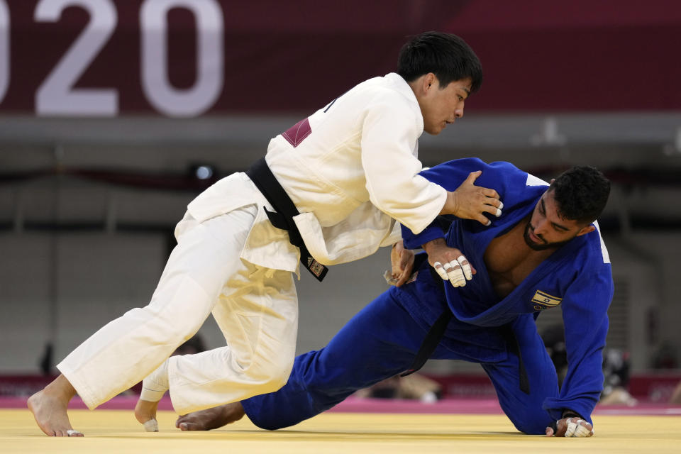 An Changrim of South Korea, left, and Tohar Butbul of Israel compete during their men's -73kg quarterfinal judo match at the 2020 Summer Olympics in Tokyo, Japan, Monday, July 26, 2021. (AP Photo/Vincent Thian)