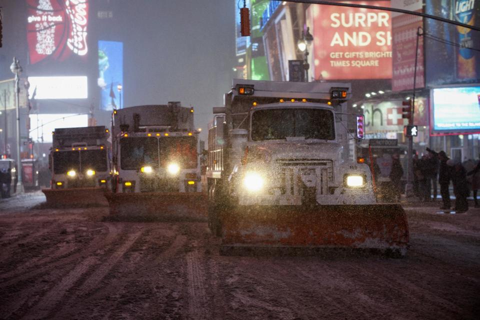 New York City plow trucks clear streets of Times Square during snow fall in Times Square, Midtown, New York