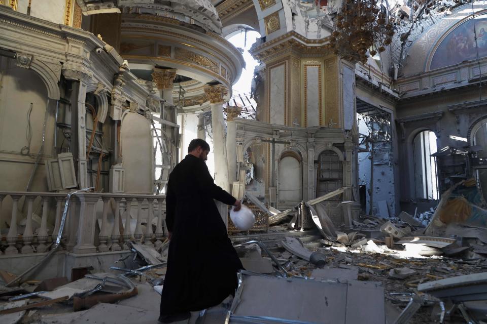 A priest examines the damages after the destruction of the Transfiguration Cathedral building as a result of a missile strike in Odesa, on July, 2023, amid the Russian invasion of Ukraine. Ukraine on Sunday said the death toll from overnight strikes by Russia on the port of Odesa rose to two, with 22 people wounded, including four children. (Photo by Oleksandr GIMANOV / AFP) (Photo by OLEKSANDR GIMANOV/AFP via Getty Images) ORIG FILE ID: AFP_33PP9AG.jpg