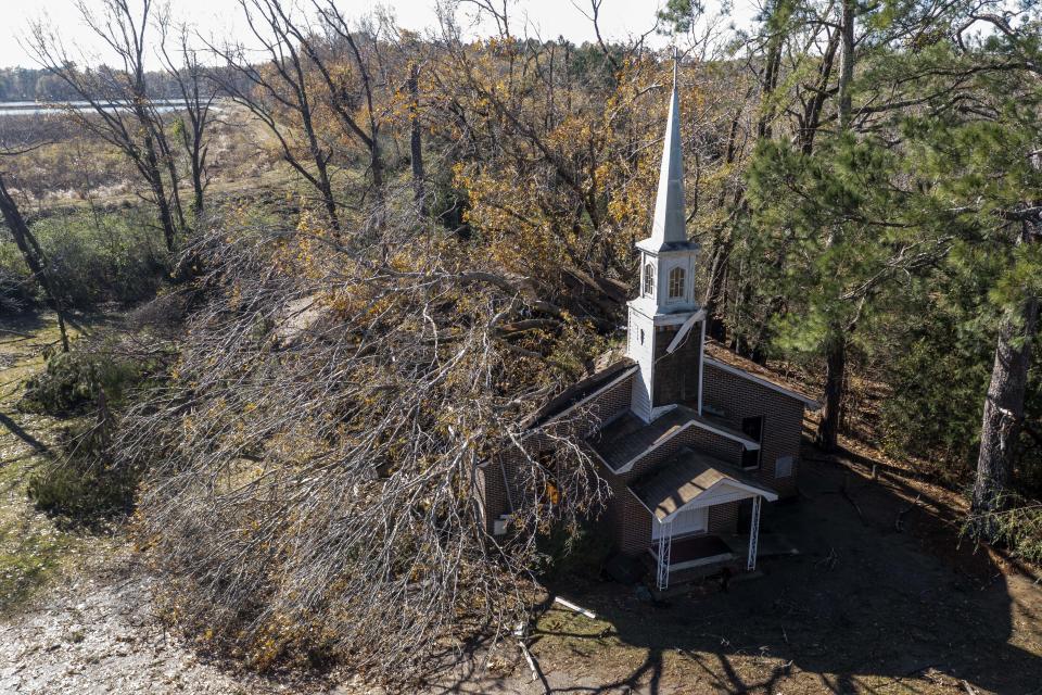 This aerial image shows a fallen tree that damaged Ezekiel Baptist Church on West End Street In the aftermath from Tuesday's severe weather, Wednesday, Nov. 30, 2022, in Eutaw, Ala. (AP Photo/Vasha Hunt)