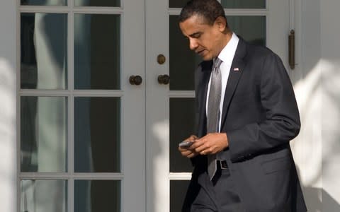 President Obama famously used a specially modified BlackBerry - Credit: AFP