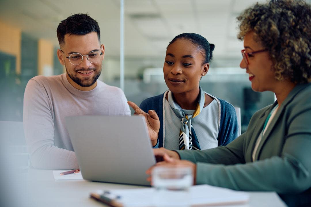 couple discussing paperwork with official