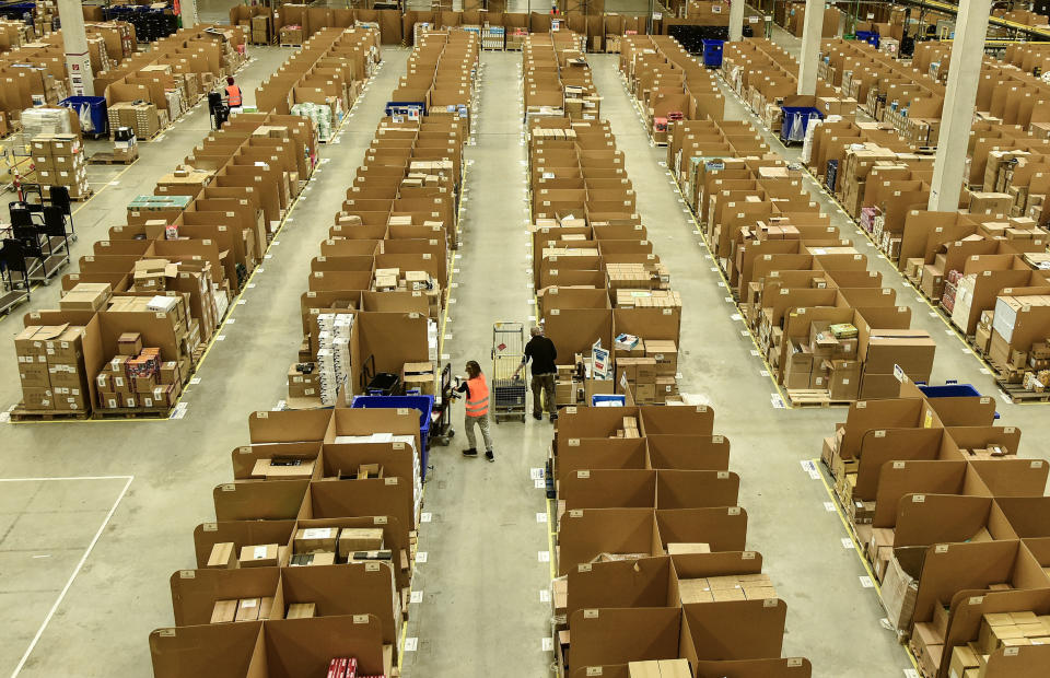 FILE - In this Nov. 14, 2018 photo workers collect goods for purchase orders at the giant storehouse of the Amazon Logistic Center in Rheinberg, Germany. Workers at two Amazon distribution centers in Germany have gone on strike as part of a push for improved work conditions, leading to fears that Christmas orders may not arrive in time. The German news agency dpa reported that workers in Leipzig in eastern Germany and Werne in western Germany went on strike early Monday. (AP Photo/Martin Meissner)
