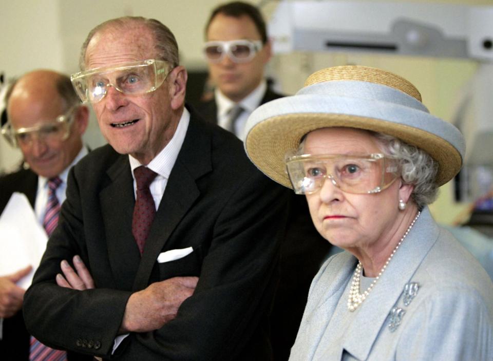 <p>The Duke of Edinburgh and Queen Elizabeth II wear safety glasses during a laser surgery demonstration at the University College Hospital, London, during a tour of the new facility which was officially opened by the Queen. (Photo credit: PA/PA Archive/PA Images) </p>