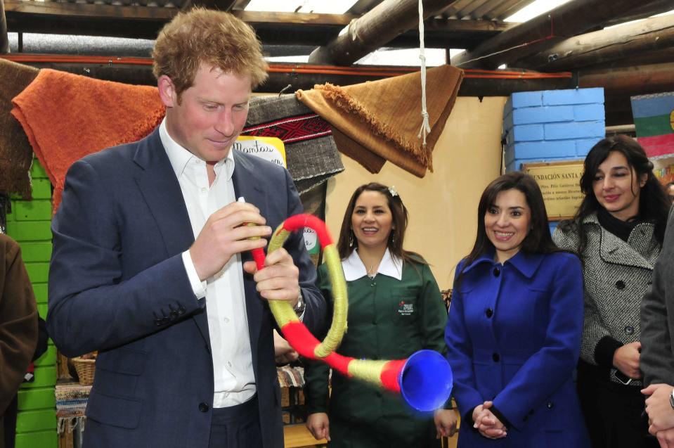 Britain's Prince Harry holds a plastic "trutruca" during a visit to Integra Foundation in Santiago