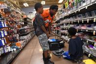 <p>Denver Broncos tight end Virgil Green, #85 shops with Samari Jelks, 12, left, and Darrell Hugley-Jones, 9, right, for school supplies at King Soopers Marketplace on July 25, 2016 in Parker, Colorado. </p>