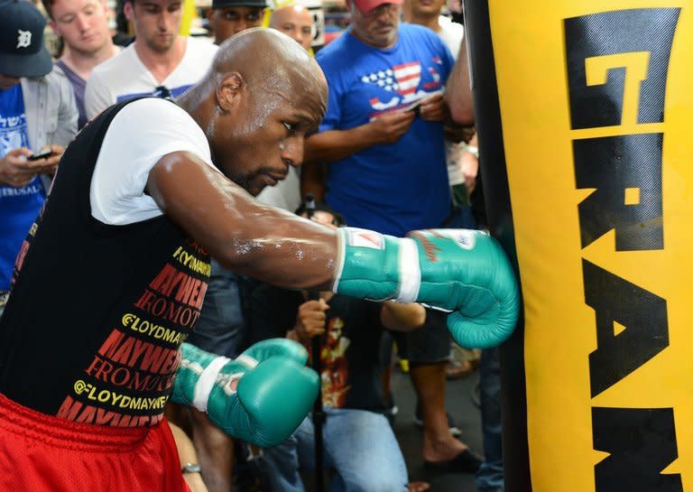 Boxer Floyd Mayweather Jr. hits a heavy bag as he works out at the Mayweather Boxing Club on August 28, 2013 in Las Vegas. He admitted his undefeated record had been partly built on the backs of handpicked opponents