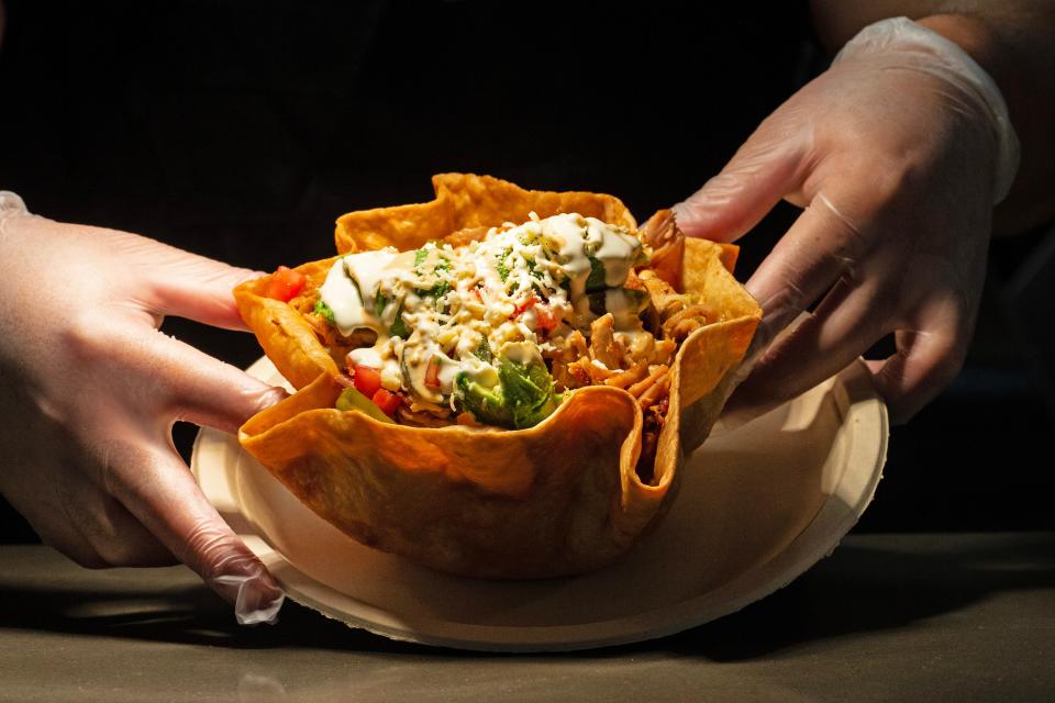 Chef Francisco Lara shows the chicken taco salad from Taqueria El Chingon, a restaurant installation offering tacos inside the DE.CO food hall in downtown Wilmington on Thursday, March 16, 2023.