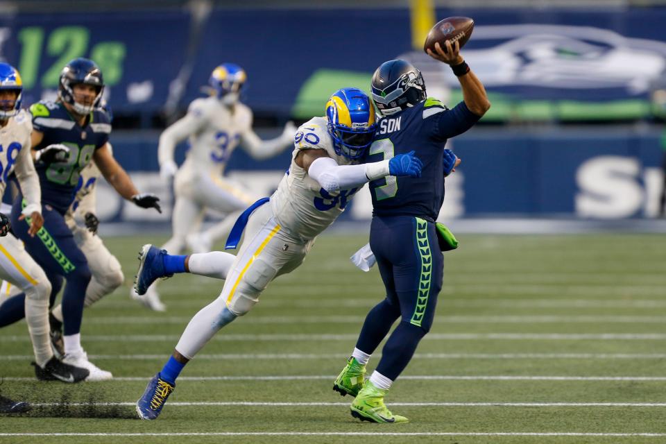 Los Angeles Rams defensive end Michael Brockers pressures Seattle Seahawks quarterback Russell Wilson during a playoff game Jan. 9, 2021 in Seattle.
