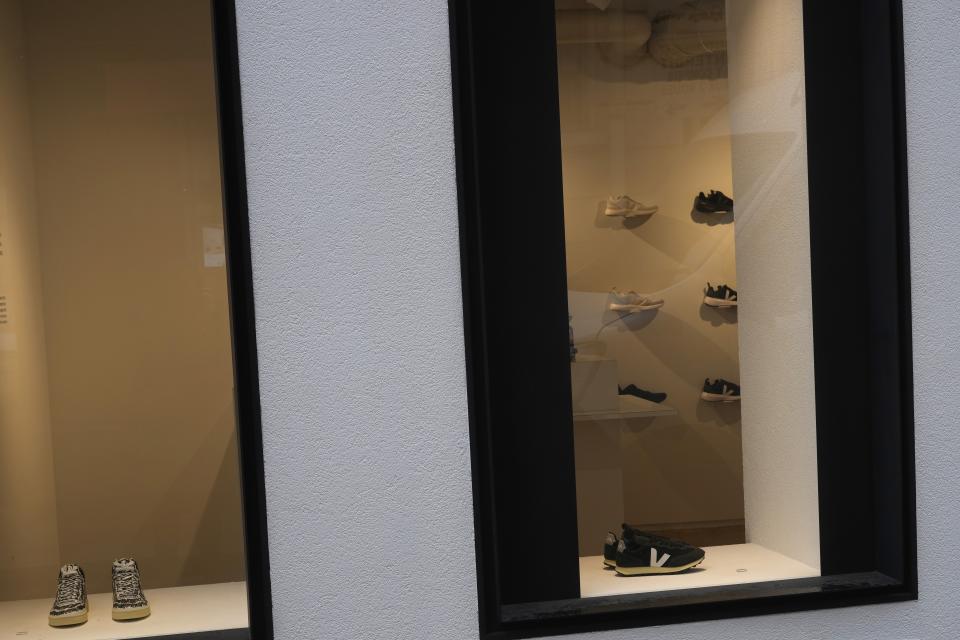 Shoes are visible in a Veja shoe store in Paris, Monday, Jan. 9, 2023. Veja, an expensive global sneaker brand, is producing sneaker soles made of native Brazilian Amazon rubber in collaboration with local rubber-tapping cooperatives. (AP Photo/Thibault Camus)