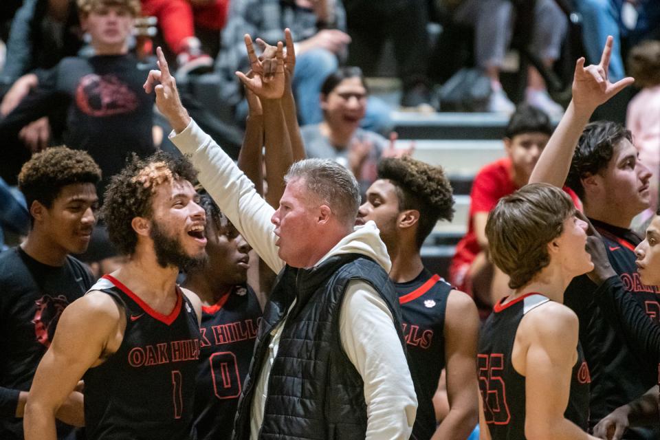 The Oak Hills boys basketball team celebrates after topping Hesperia on Jan. 19, 2023.