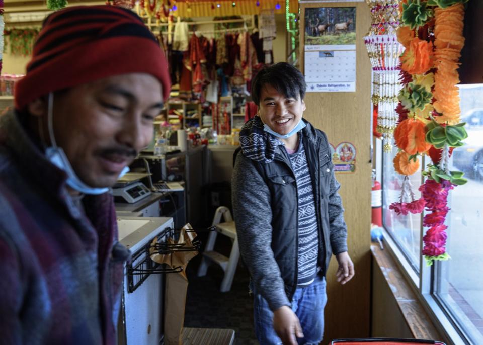 Two men stand in a store