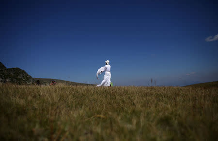 A follower of the Universal White Brotherhood, an esoteric society that combines Christianity and Indian mysticism set up by Bulgarian Peter Deunov in the 1920s, is pictured after performing a dance-like ritual called "paneurhythmy" in Rila Mountain, Bulgaria, August 19, 2017. REUTERS/Stoyan Nenov