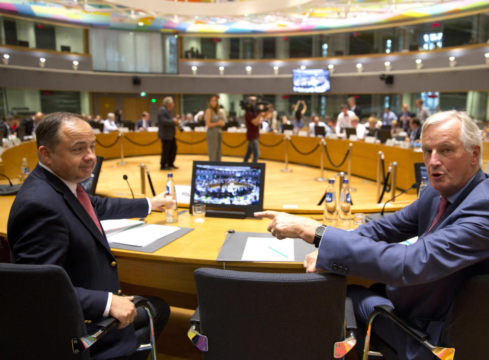 EU chief Brexit negotiator Michel Barnier, right, speaks with Poland's European Affairs Minister Konrad Szymansk, left, during a General Affairs Article 50 Council at the Europa building in Brussels, Tuesday, Sept. 18, 2018. A top European Union official on Tuesday said Britain and the EU could yet fail to reach an agreement on the terms of their divorce, just six months before the U.K. is due to leave the bloc. (AP Photo/Virginia Mayo)