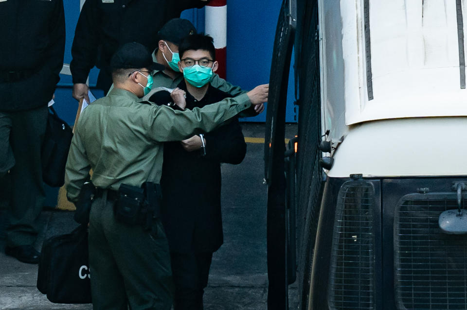 HONG KONG, CHINA - DECEMBER 18: Pro-democracy activist Joshua Wong prepares to board a Correctional Service Department van at Lai Chi Kok ahead of a court hearing at Lai Chi Kok Reception Centre on December 18, 2020 in Hong Kong, China. Wong was indicted for taking part in an unauthorized assembly over an anti-mask law protest. (Photo by Anthony Kwan/Getty Images)