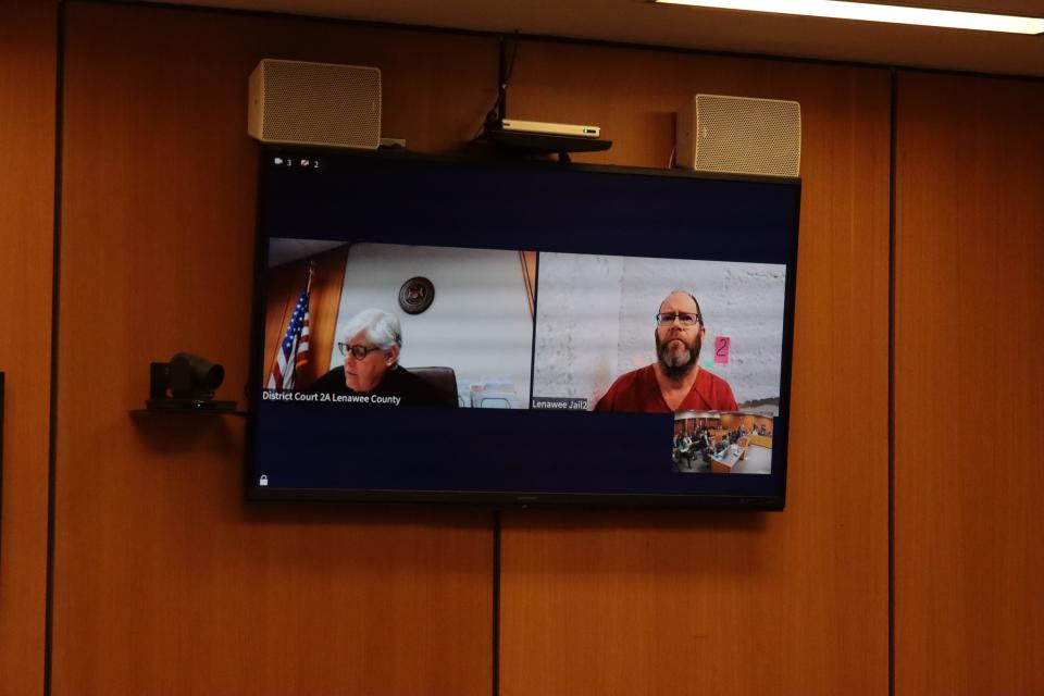 Defendant Dale Warner of Tipton, right in the monitor, is pictured during a hearing on his bond Nov. 27 in Lenawee County District Court. Dales for a preliminary examination have been set.