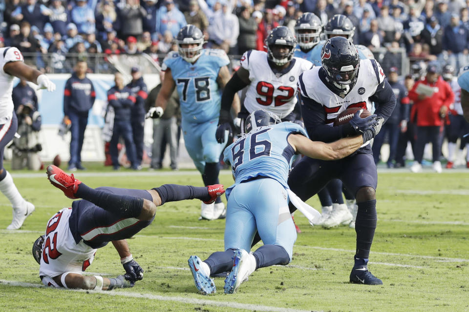Houston Texans outside linebacker Whitney Mercilus, right, intercepts a pass intended for Tennessee Titans tight end Anthony Firkser (86) in the first half of an NFL football game Sunday, Dec. 15, 2019, in Nashville, Tenn. Mercilus returned the ball 86 yards. (AP Photo/James Kenney)