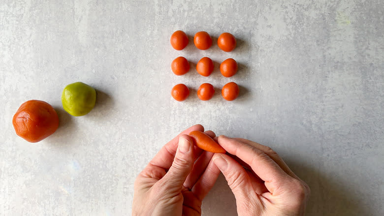 Orange balls of marzipan and a carrot shape