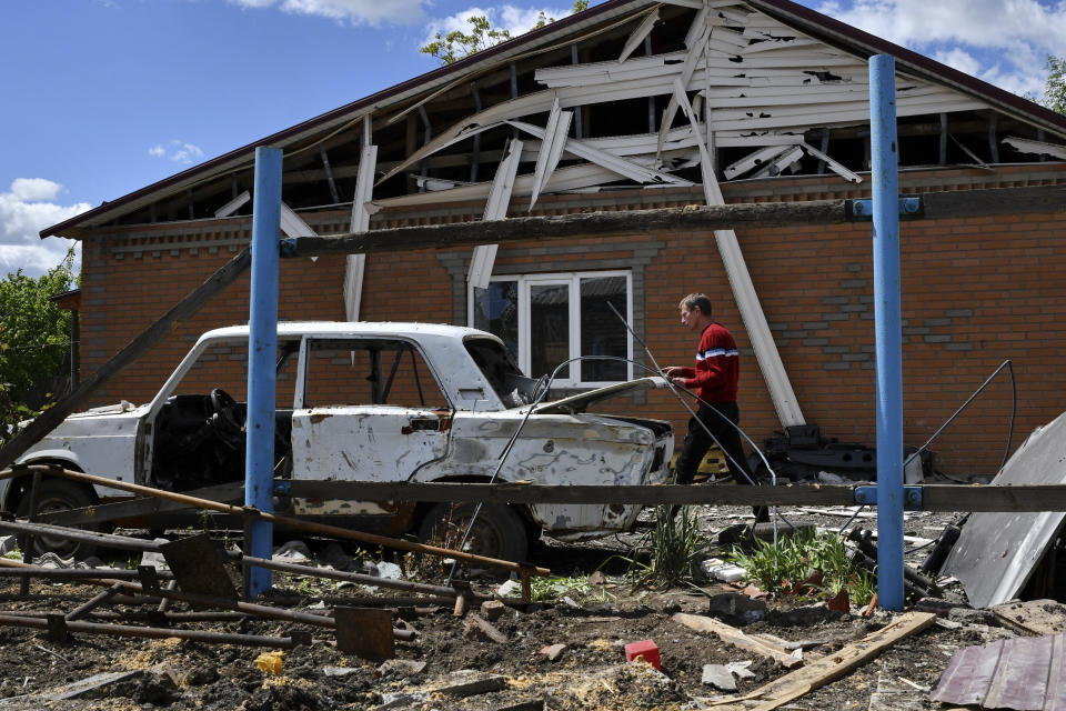 Alexander walks around his house destroyed by Russian shelling in Toretsk, Donetsk region, Ukraine, Monday, May 16, 2022. (AP Photo/Andriy Andriyenko)