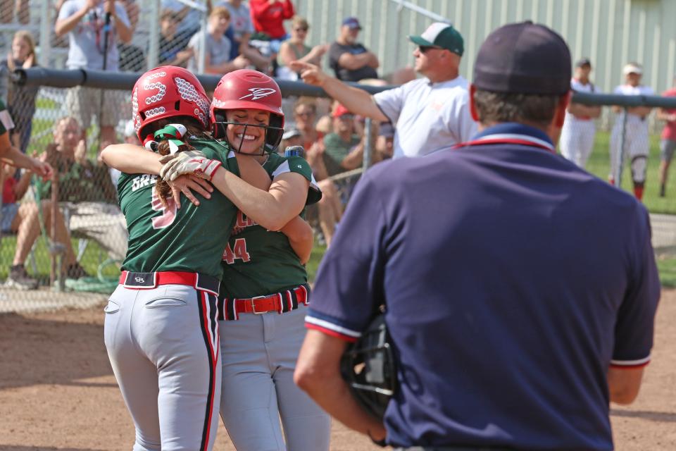 Porter Gregory, left, embraces Sydney Overmyer after Overmyer scored Oak Harbor's first run in the third inning.