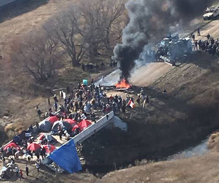 Protestors against the Dakota Access Pipeline stand-off with police in this aerial photo of Highway 1806 and County Road 134 near the town of Cannon Ball, North Dakota, U.S., October 27, 2016. Morton County Sheriff's Office/Handout via Reuters