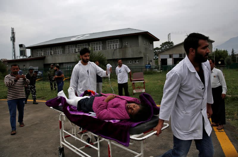 An injured is rushed for treatment at Sher-i-Kashmir Institute of Medical Sciences hospital in Srinagar