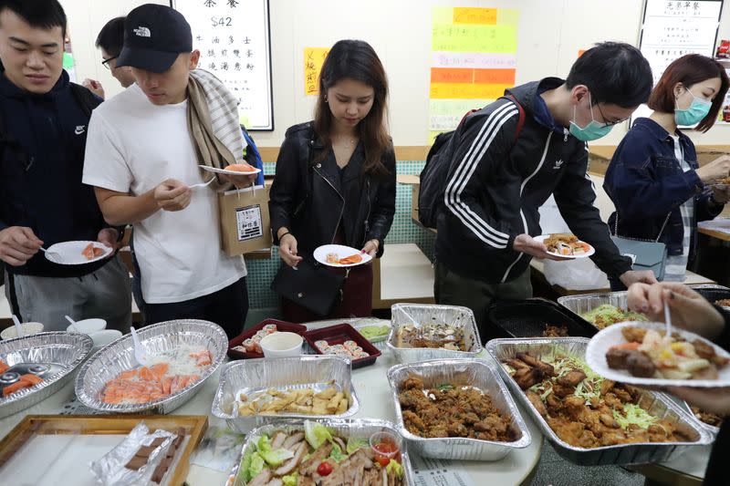 Protesters queue for a free Christmas dinner offered by a local restaurant in Hong Kong