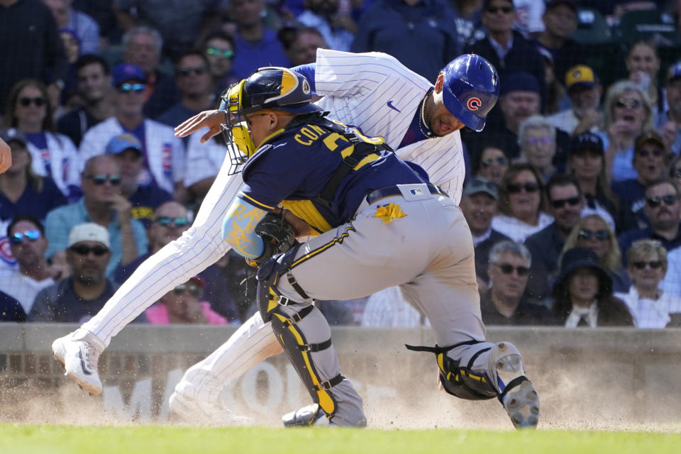 Milwaukee Brewers catcher William Contreras tags Chicago Cubs' Christopher Morel out at home during the eighth inning of a baseball game Wednesday, Aug. 30, 2023, in Chicago. (AP Photo/Charles Rex Arbogast)