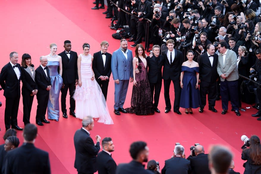 Group of celebrities including Yorgos Lanthimos, Ed Guiney, Mamoudou Athie, Jesse Plemons, Willem Dafoe, Hong Chau, Joe Alwyn, Emma Stone standing on the 'Kinds Of Kindness' Red Carpet at the 77th annual Cannes Film Festival.