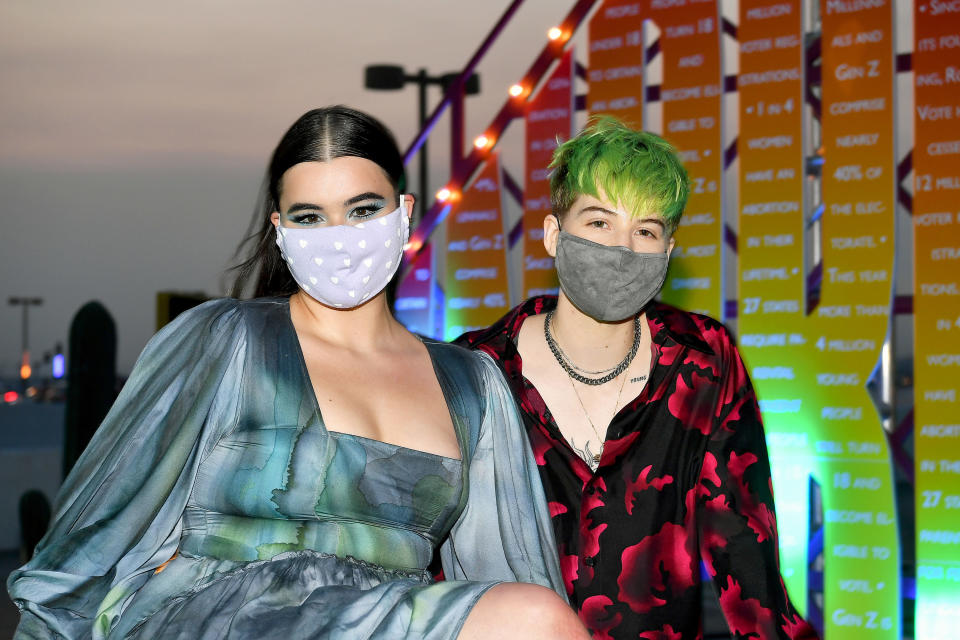 the two posing with face masks