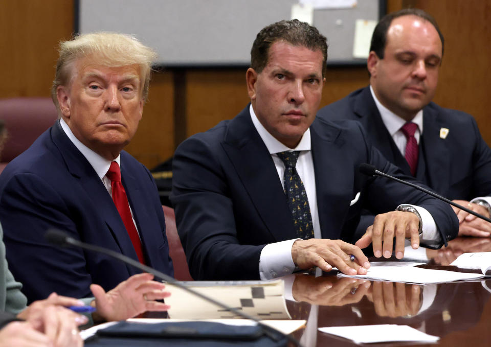Former President Donald Trump sits with attorneys Joe Tacopina and Boris Epshteyn inside Manhattan Criminal Court during his arraignment on Tuesday. (Photo by Andrew Kelly-Pool/Getty Images)