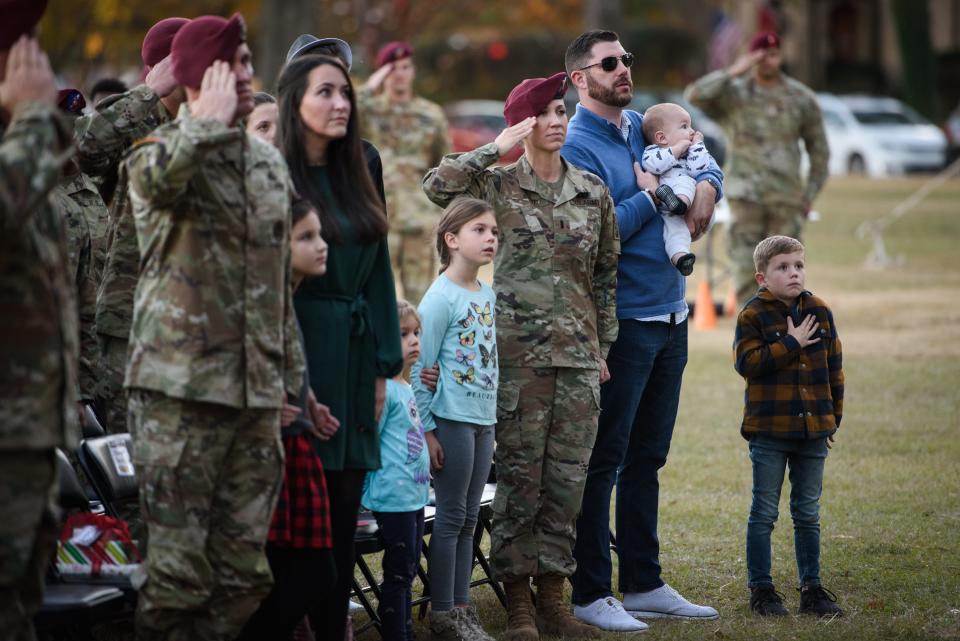 1st Lt. Stephanie Boyd and her family as the National Anthem plays at the Fort Bragg Family of the Year and Tree Lighting ceremony on Friday, Dec. 3, 2021. The Boyd family was among the nominees for family of the year.