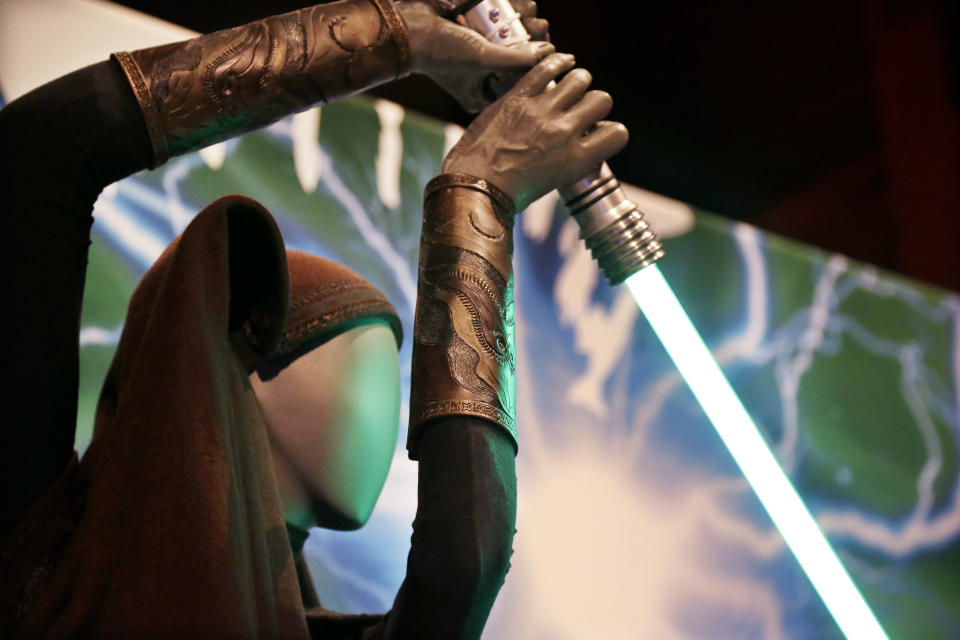 A Sith robe and lightsaber. (AP Photo/Elaine Thompson)