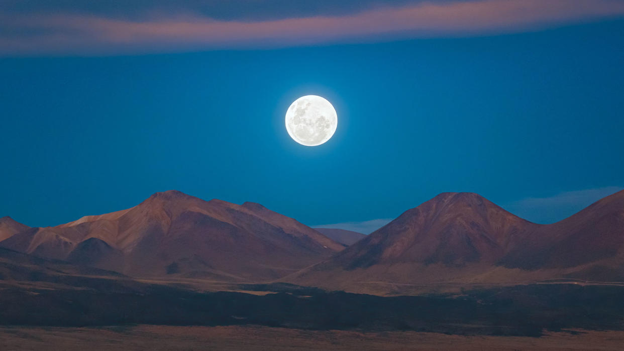  A full moon rises in Chile's Atacama Desert. 