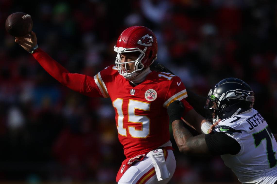 Kansas City Chiefs quarterback Patrick Mahomes (15) throws a pass while chased by Seattle Seahawks defensive tackle Quinton Jefferson (77) during the second quarter on Saturday, Dec. 24, 2022, in Kansas City, MO.