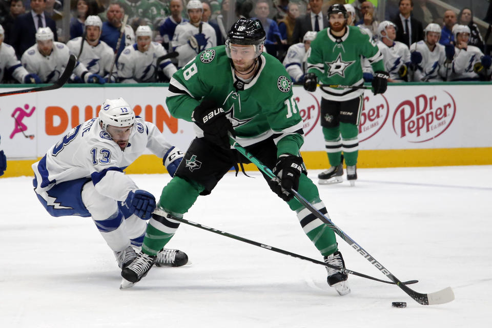 Dallas Stars center Jason Dickinson, right, controls the puck on Tampa Bay Lightning center Cedric Paquette, left, during the first period of an NHL hockey game in Dallas, Monday, Jan. 27, 2020. (AP Photo/Ray Carlin)