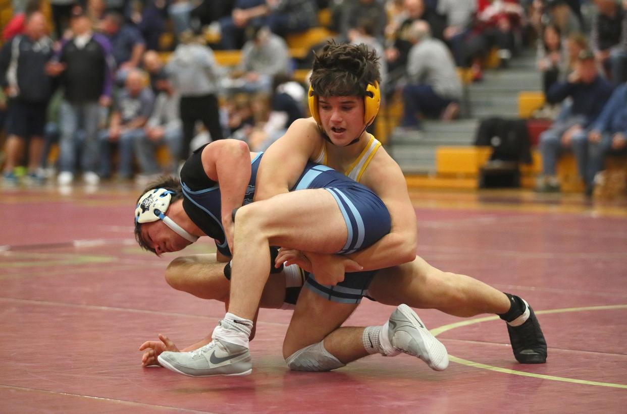 Quaker Valley's Marcus Richey (black) locks onto Burrell's Shawn Oden (blue) during their 145 pound match while competing in the WPIAL 2A Wrestling Team Semifinals Saturday afternoon at Chartiers-Houston High School in Houston, PA.