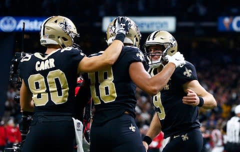 New Orleans Saints quarterback Drew Brees (9) and wide receiver Austin Carr (80) celebrate with wide receiver Keith Kirkwood (18) after Brees' touchdown pass to Kirkwood in the second half of an NFL football game against the Atlanta Falcons - Credit: AP Photo/Butch Dill