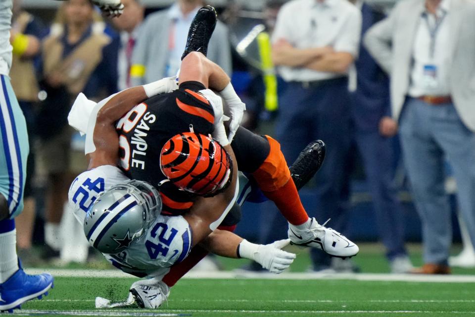 Cincinnati Bengals tight end Drew Sample (89) is tackled by Dallas Cowboys linebacker Anthony Barr (42) in the second quarter of an NFL Week 2 game, Sunday, Sept. 18, 2022, at AT&T Stadium in Arlington, Texas. Sample left the game after the play. 