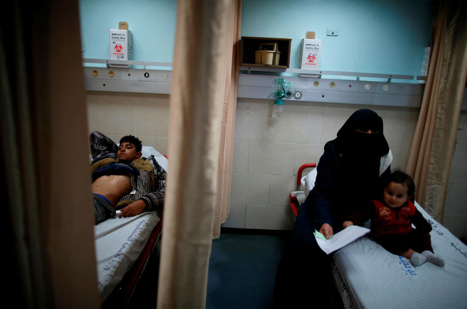 <p>Palestinian boy Ahmed Abu Saman, 16, who was injured in a car accident, lies on a bed at the emergency room at Shifa hospital, Gaza’s largest public medical facility, in Gaza City, March 29, 2017. (Photo: Mohammed Salem/Reuters) </p>