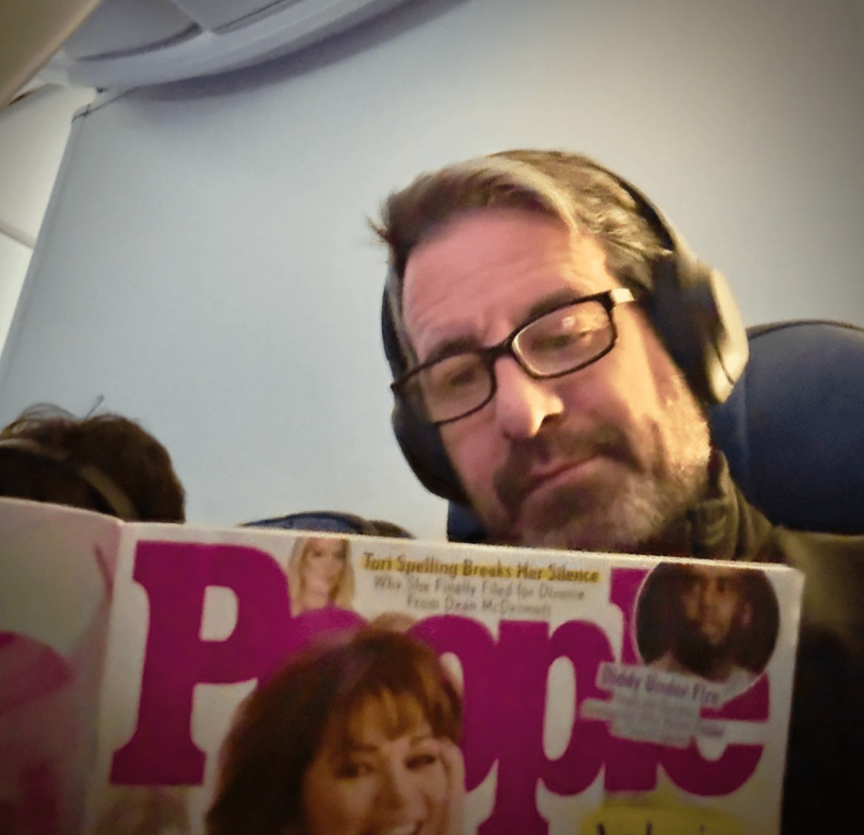 Mike Goodnough reading a People magazine with Valerie Bertinelli on the cover. (Instagram/therealhoarse)