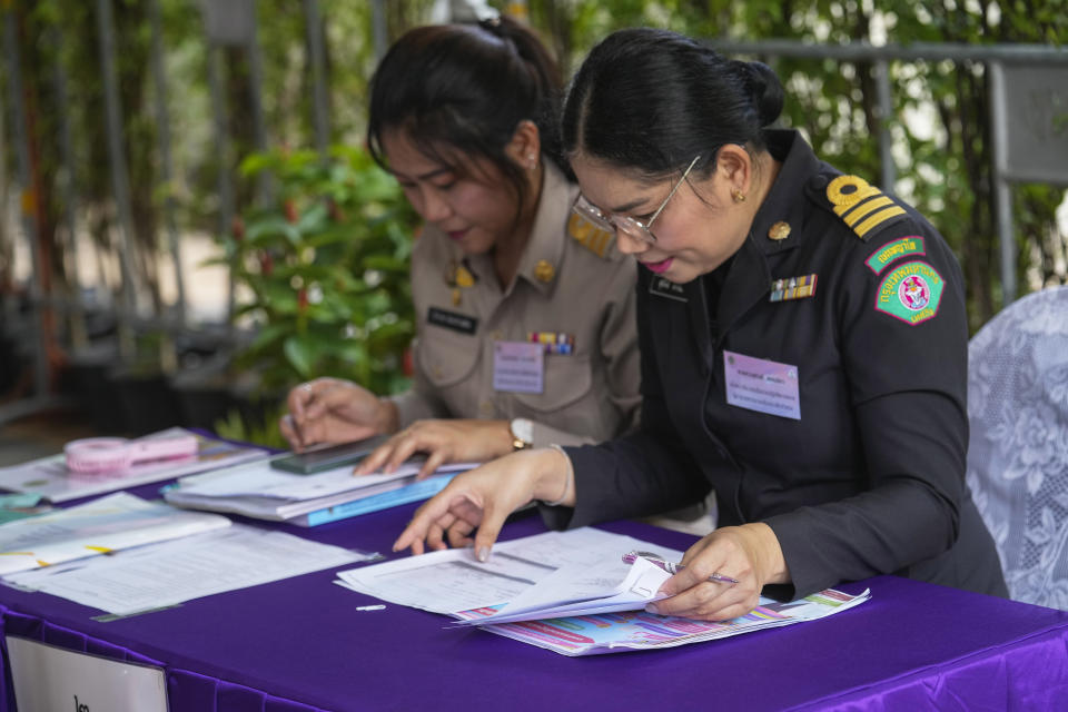 Thai officer check document from potential candidates to become members of Thailand's next Senate arrive at the Phaya Thai district office in Bangkok on Monday, May 20, 2024. Thailand on Monday officially kicked off the task of selecting a new set of Senators, a process that has become part of the ongoing war between progressive forces hoping for democratic political reforms and conservatives seeking to keep the status quo.(AP Photo/Sakchai Lalit)