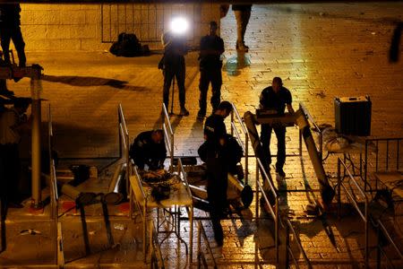 Israeli security forces remove metal detectors which were recently installed at an entrance to the compound known to Muslims as Noble Sanctuary and to Jews as Temple Mount in Jerusalem's Old City July 25, 2017. REUTERS/Ammar Awad